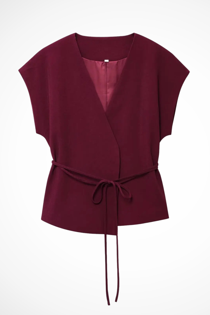 Stylish women's sleeveless suit set with v-neck wrap top & flowing wide leg trousers. Coordinated fashion.