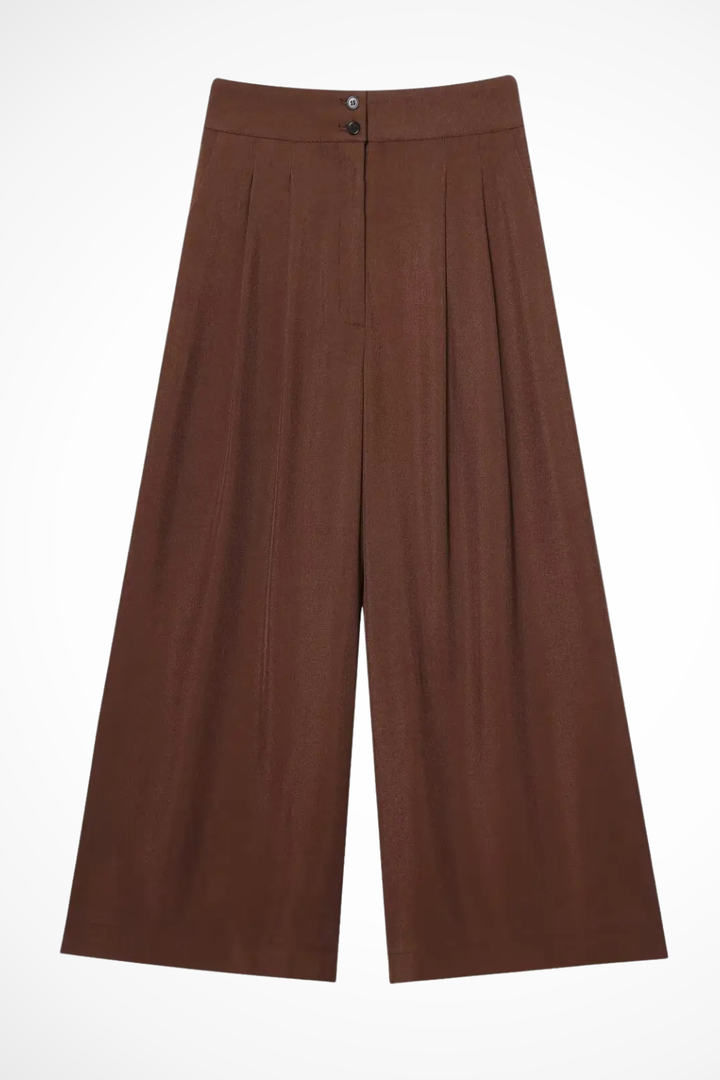 Elegant women's two-piece suit. Belted sleeveless wrap top and high-waisted wide leg trousers for events.