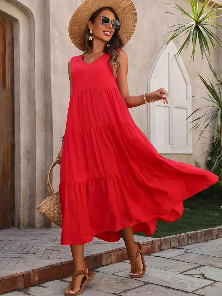 Fashionable women's sleeveless tiered maxi dress, embodying relaxed beach and vacation vibes.