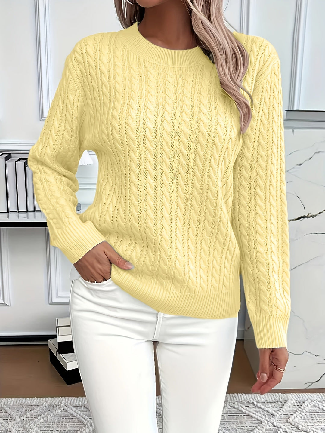Stylish women's cable knit sweater, versatile for spring and autumn, featuring a classic round neck design.