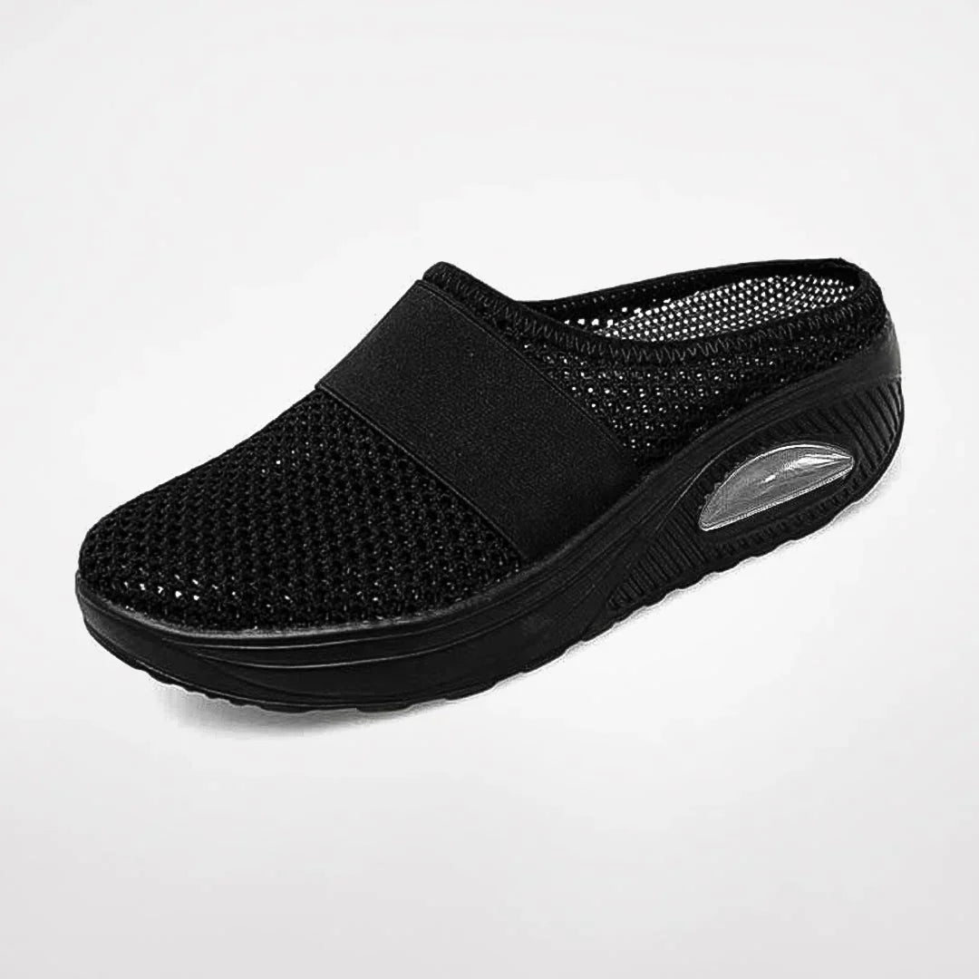 Detail shot: Women's orthopedic comfort slipper featuring integrated arch support & non-slip sole.