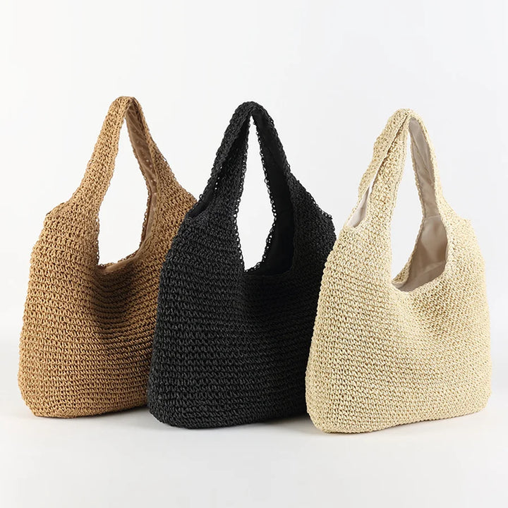 Chic women's summer straw tote bag with shoulder strap. A stylish casual accessory for beach or everyday use.