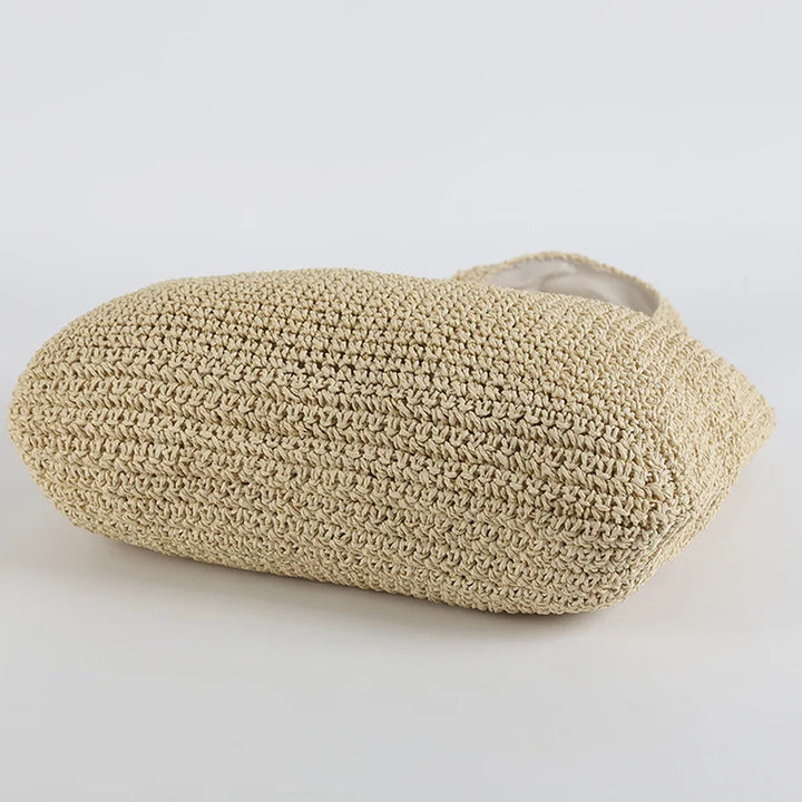 Lightweight women's straw shoulder bag, a spacious beach tote for your summer essentials. Great for vacations.