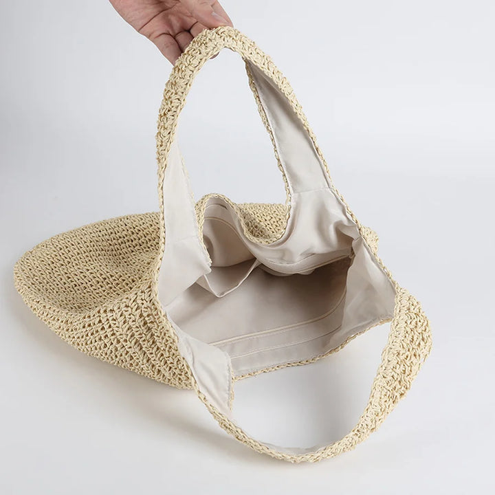 Versatile women's straw beach bag with shoulder strap. Perfect for summer, vacation, and casual fashion accessory.
