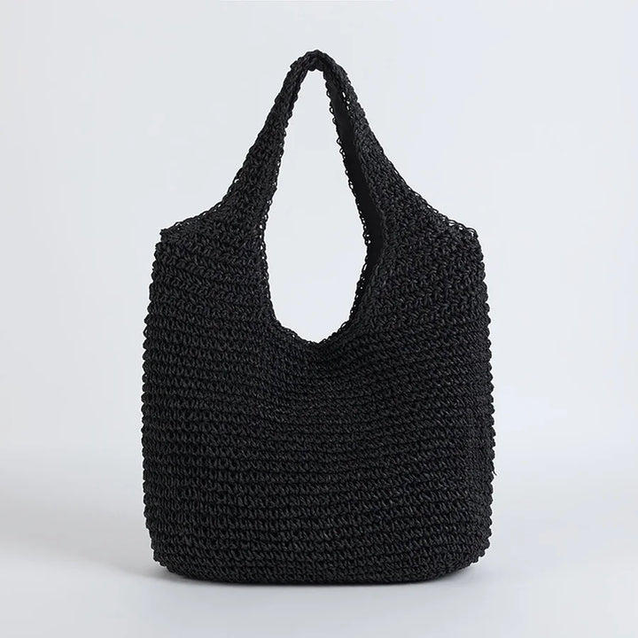 Boho-style women's straw hobo bag with long shoulder strap. Essential summer accessory for beach days & travel.