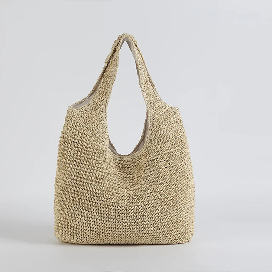 Natural woven straw women's beach bag with shoulder strap. A must-have summer tote for casual & vacation outfits.