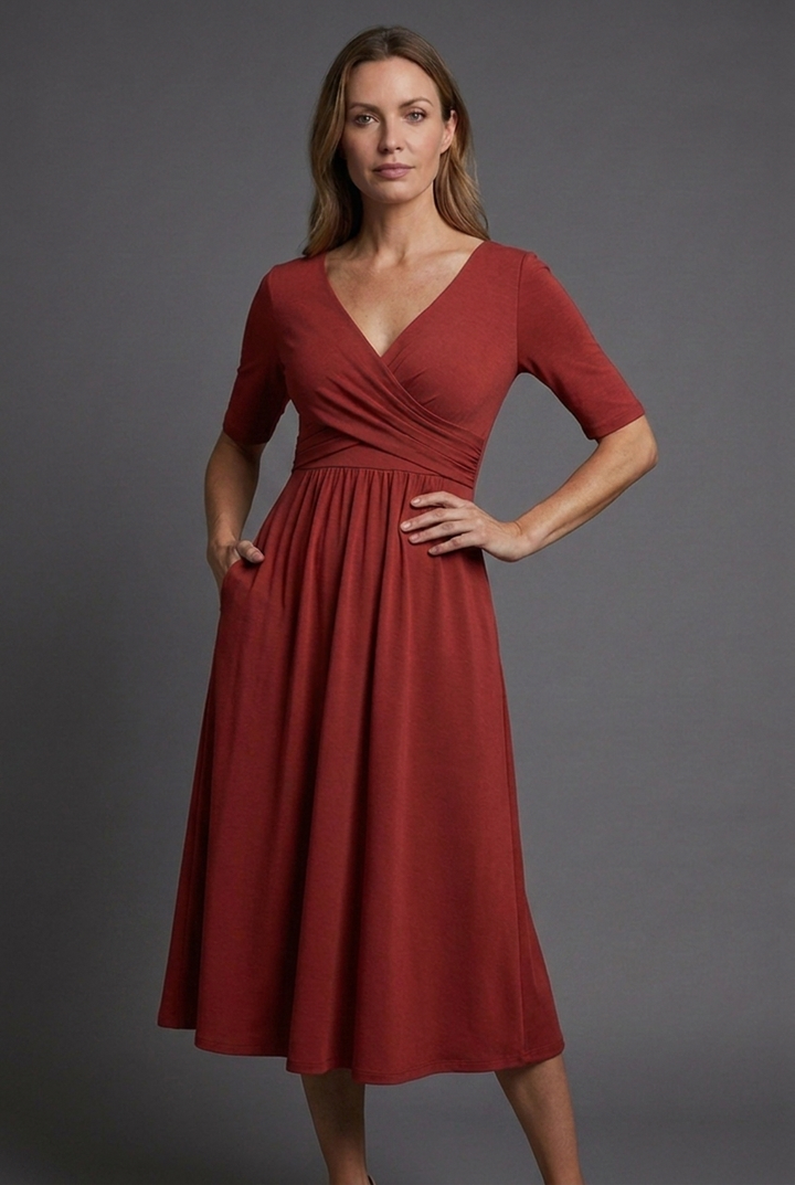 Comfortable women's short sleeve V-neck wrap midi dress. Features a stylish wrap front and functional pockets.