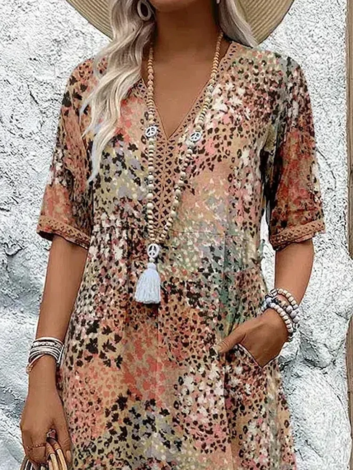Flowing & elegant women's midi dress in a vibrant pattern, perfect for movement and summer style.