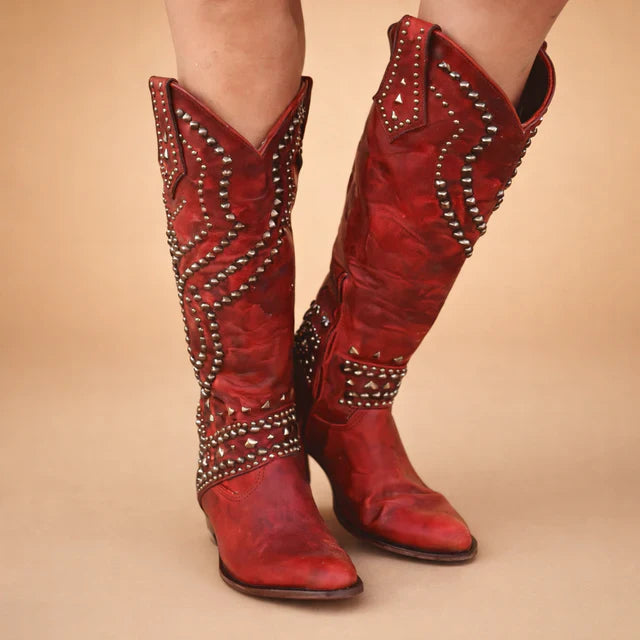 Elegant studded knee-high cowboy boots for women. Vintage Western style with a comfortable chunky heel, ideal for winter.