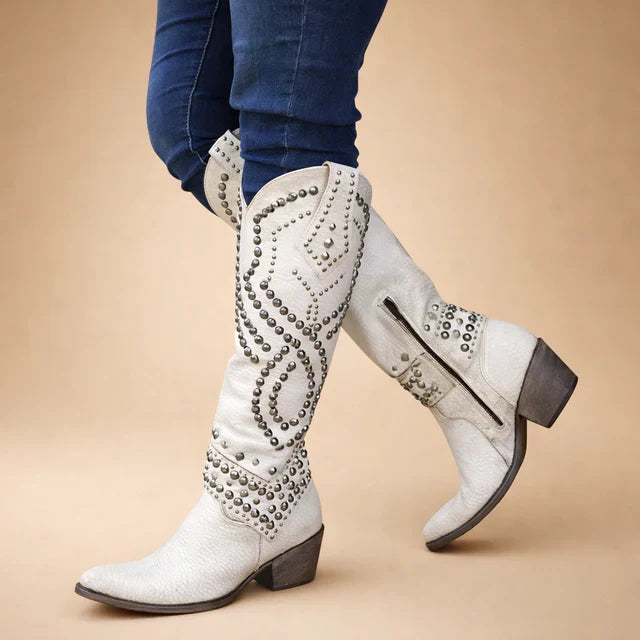 Fall fashion women's knee-high cowboy boots. Vintage Western design, studded details & chunky heel for stylish footwear.