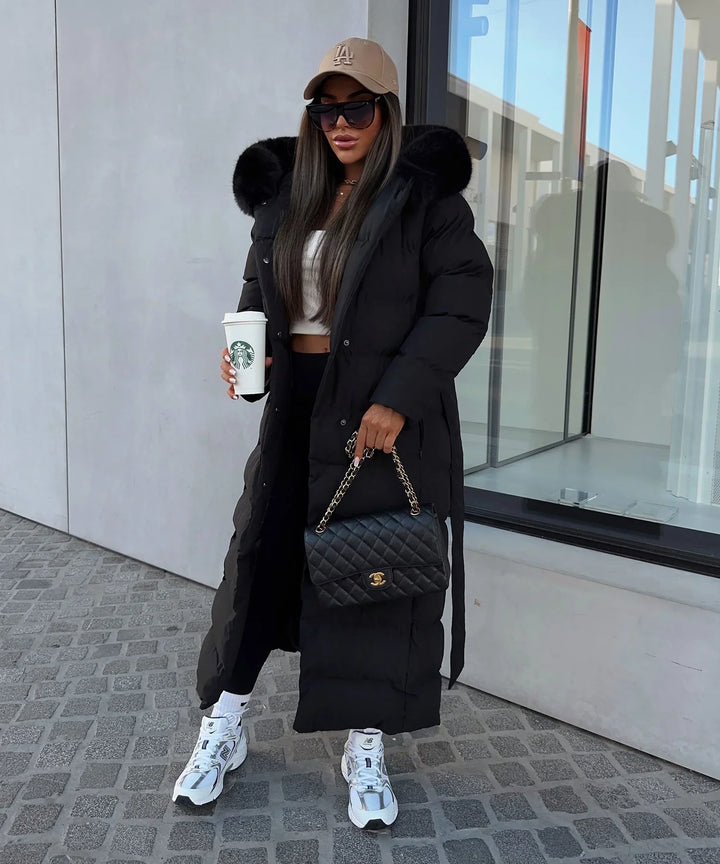 Side view of a women's stylish belted puffer maxi coat, perfect for warm winter outerwear & fashion.