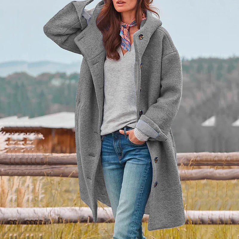 Stylish women's new hooded winter coat, providing warm, elegant comfort. Perfect long outerwear for winter fashion.