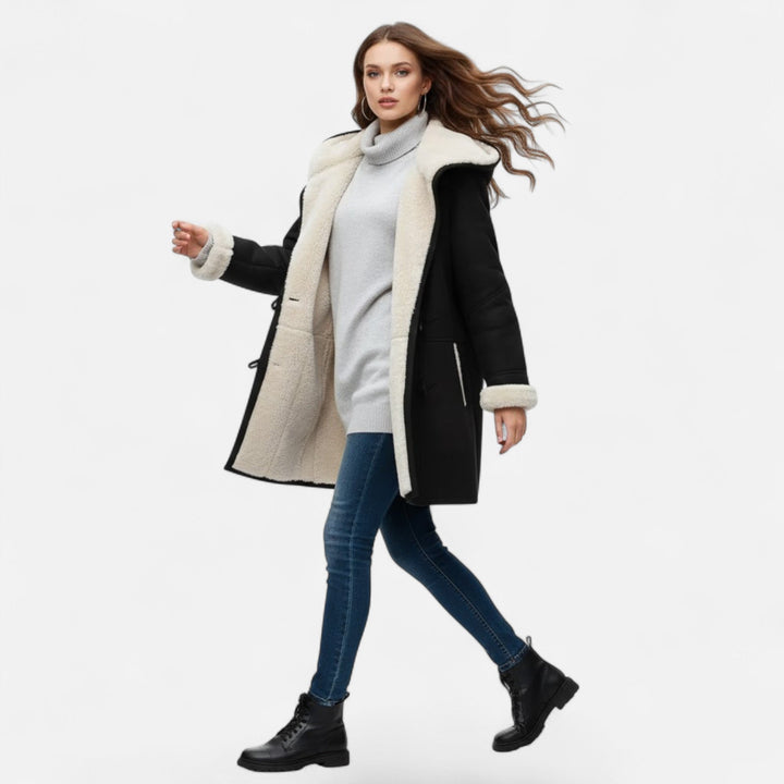 Warm button-front women's coat with hood and pockets. Essential outerwear for the fall and winter season.