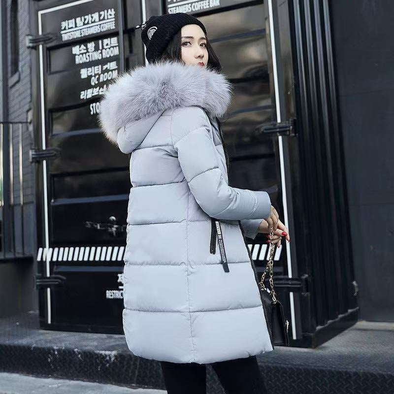Long women's winter parka coat with hood, providing excellent warmth and protection for cold weather travel.