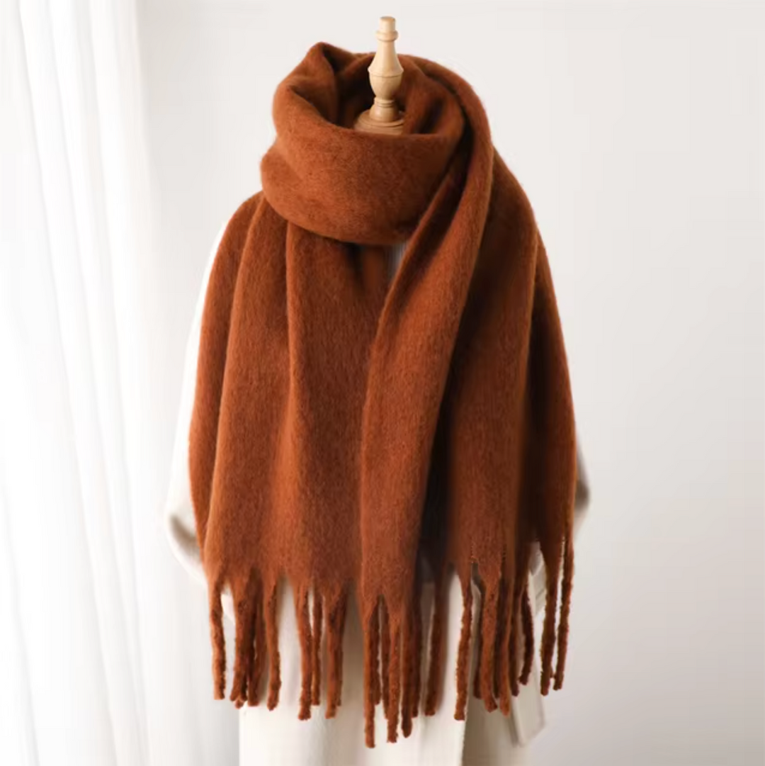 Women's cozy winter wrap, a stylish scarf with soft fringes, perfect for cold weather fashion.