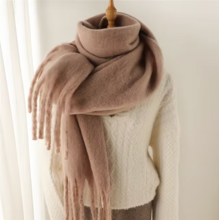 Fashionable women's winter scarf, a stylish accessory with warm fabric & elegant fringes.