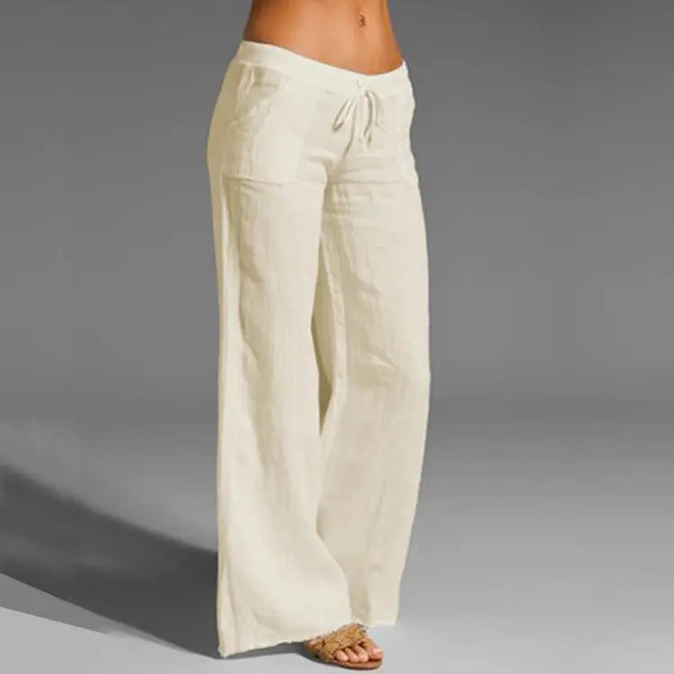 Women's white linen blend loose-fit summer trousers with elastic waist, ideal for casual wear & warm weather comfort.