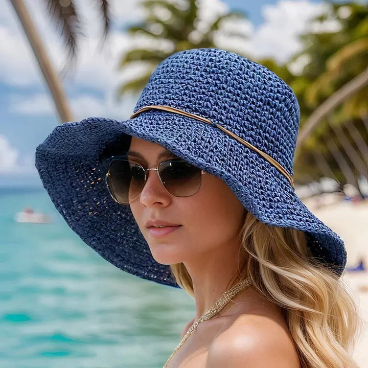 Elegant women's wide brim straw hat, perfect for sun protection at the beach, garden parties, or vacation.