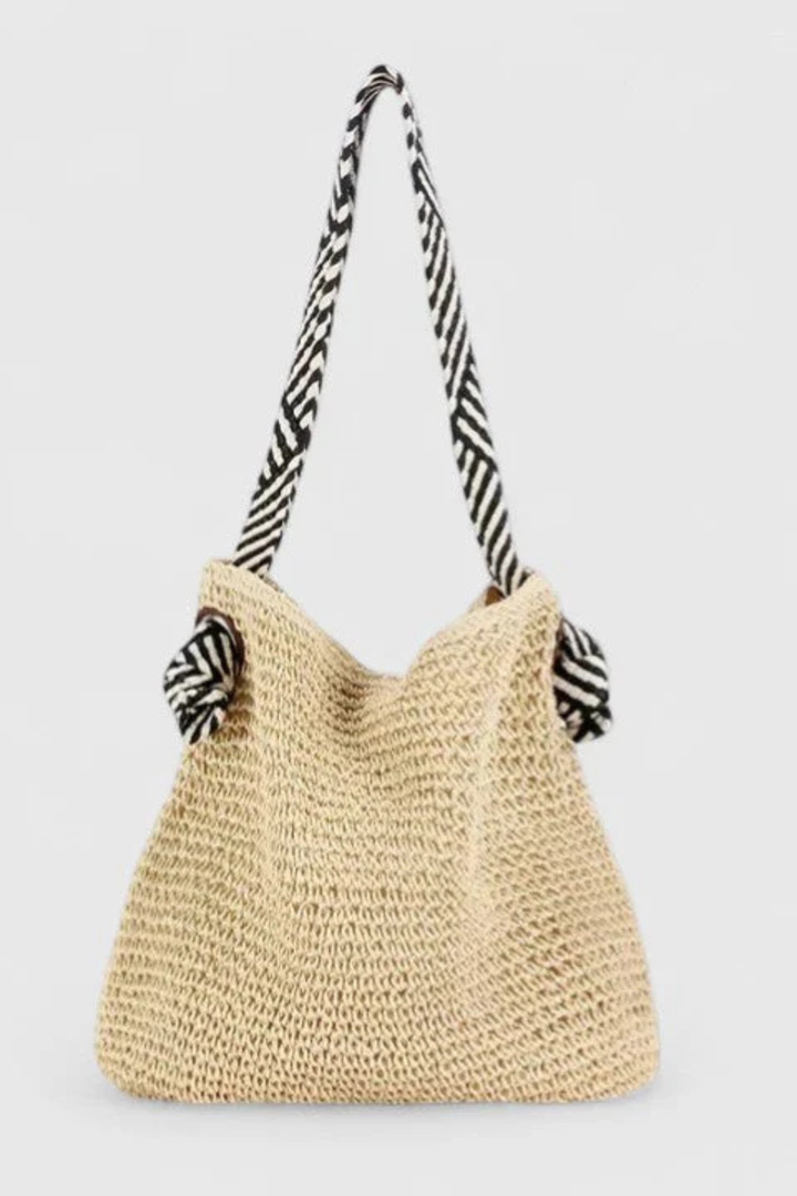 Detailed woven straw shoulder bag for women, showcasing beautiful texture & contrasting handle straps.
