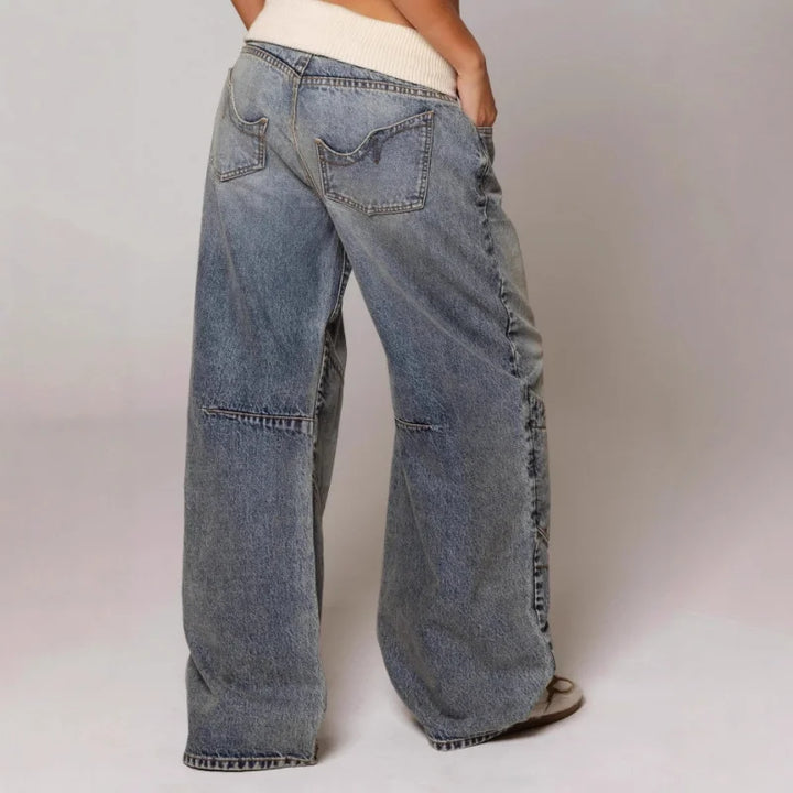 Light blue Y2K baggy wide leg jeans for women, featuring a stylish ribbed waist and unique curved seam.