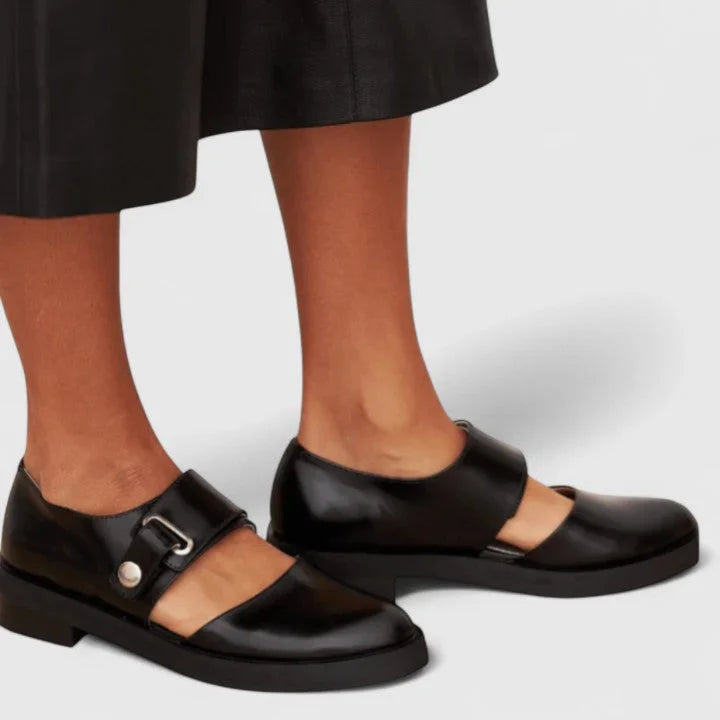 Elegant black Mary-Jane flats for women, featuring stylish side cut-outs. Perfect comfortable dress or work shoes.