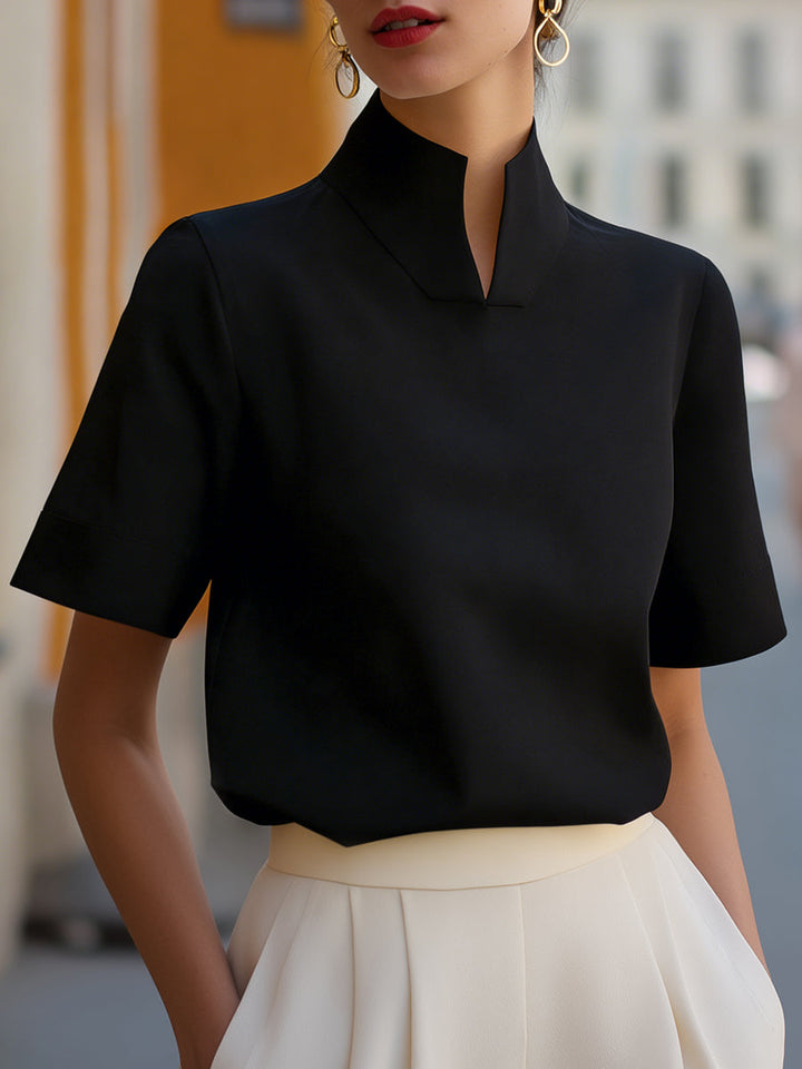 Chic ladies' short sleeve blouse with stand collar. Relaxed fit, perfect for summer office wear or elegant everyday fashion.