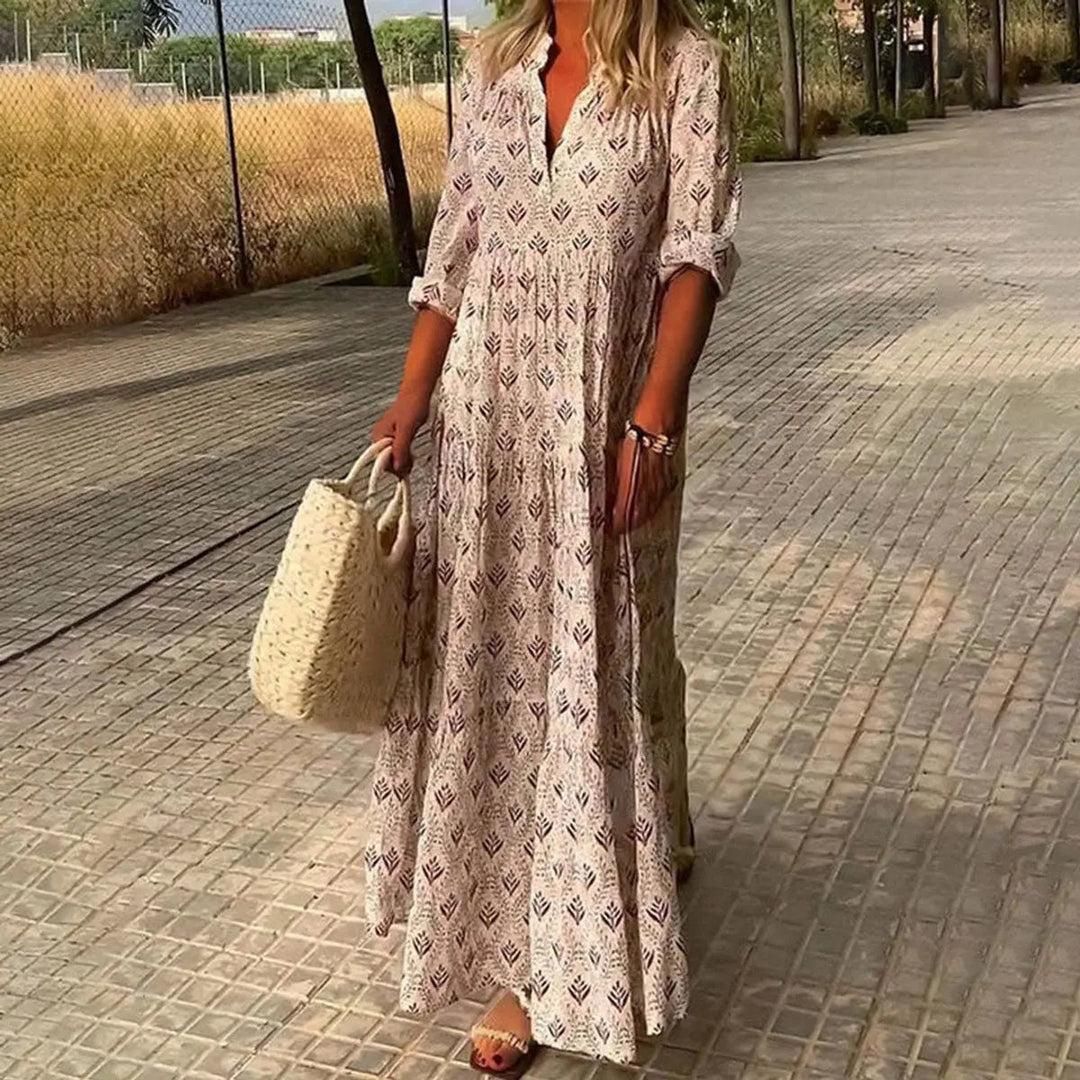 Women's V-neck maxi dress with vibrant boho floral print & elegant tiered design, suitable for parties & guest occasions.