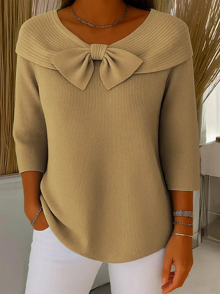 Beige women's comfortable V-neck sweater with bow accent and 3/4 length sleeves. Perfect for casual wear.