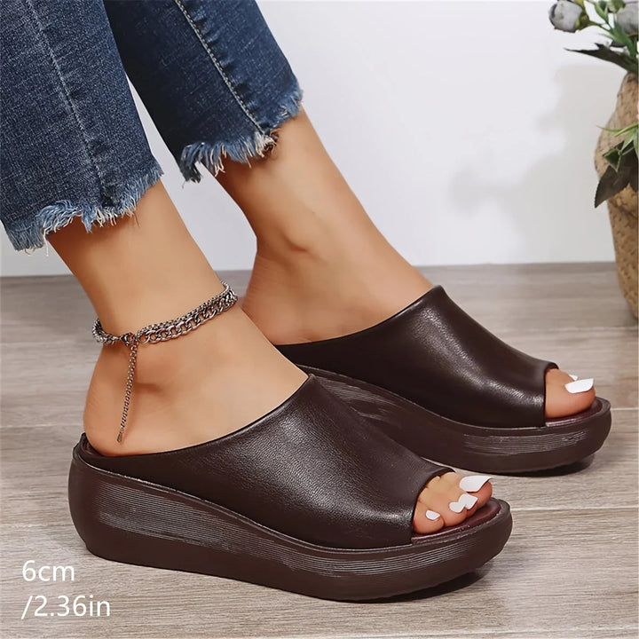 Stylish women's brown wedge sandals. Open-toe, slip-on design for casual summer footwear and comfort.