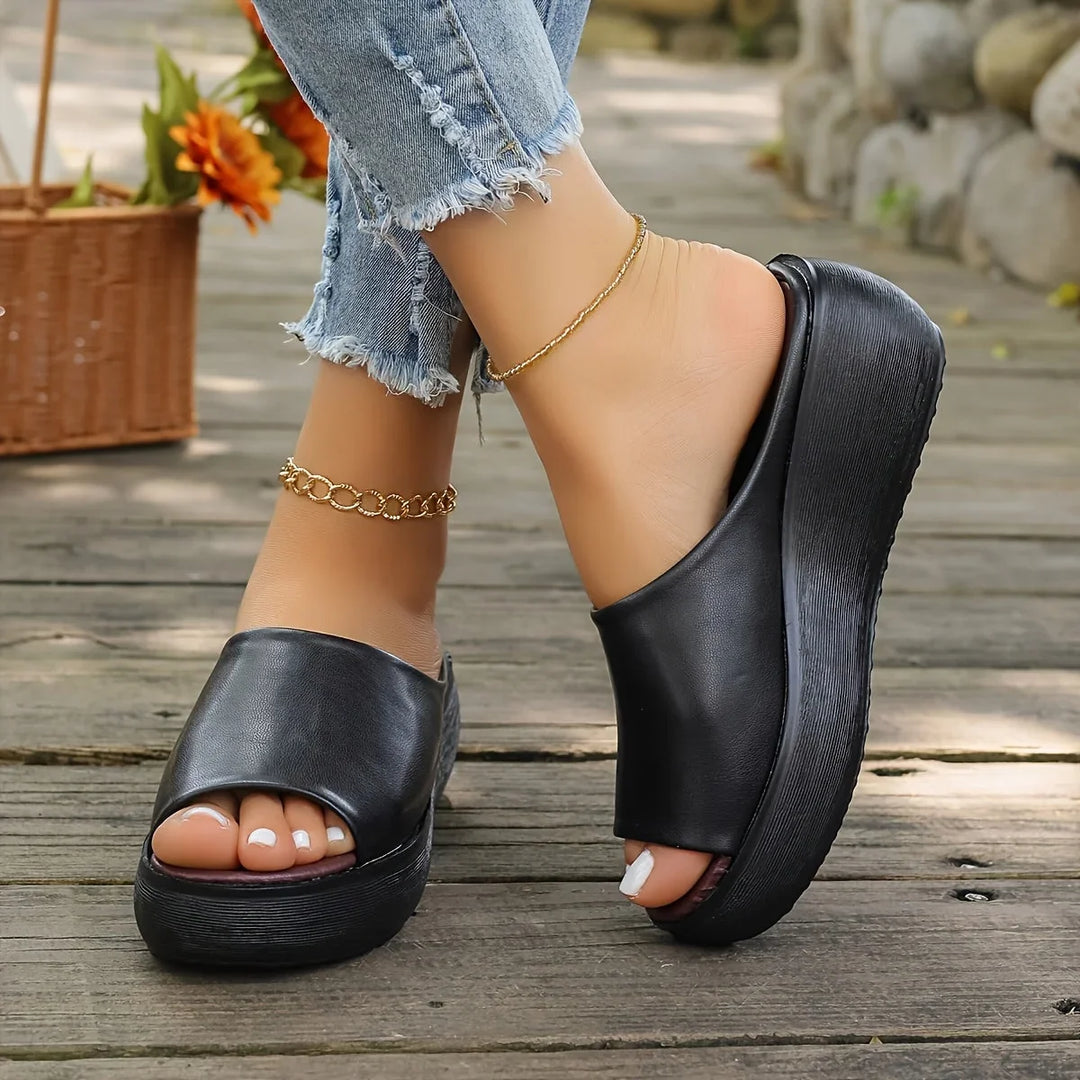 Women's brown slip-on wedge sandals. Open-toe design for effortless summer style and comfortable wear.