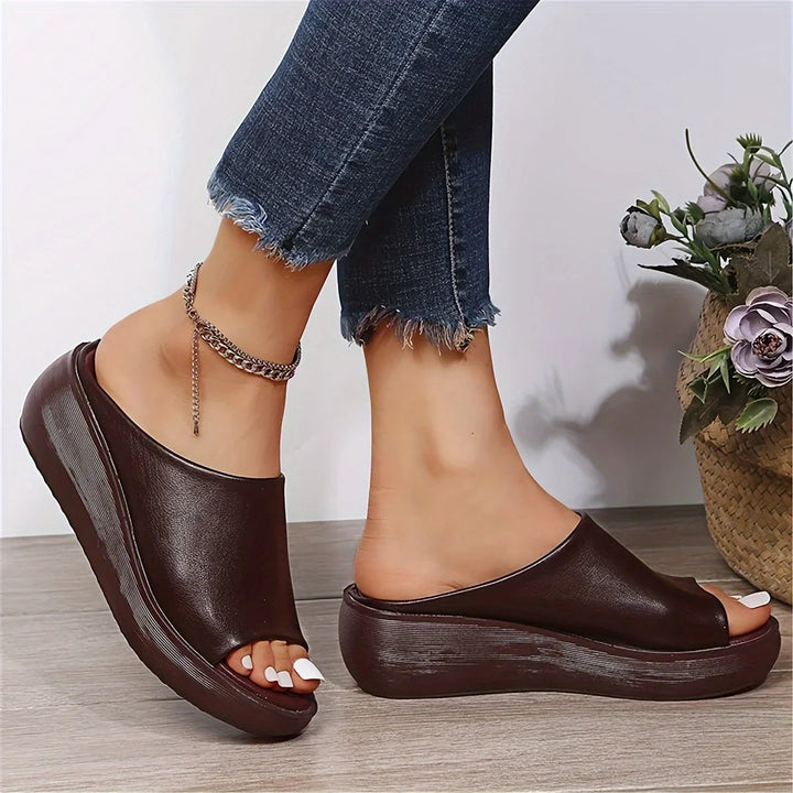 Fashionable brown women's open-toe wedge sandals. Slip-on design, perfect comfortable footwear for summer.