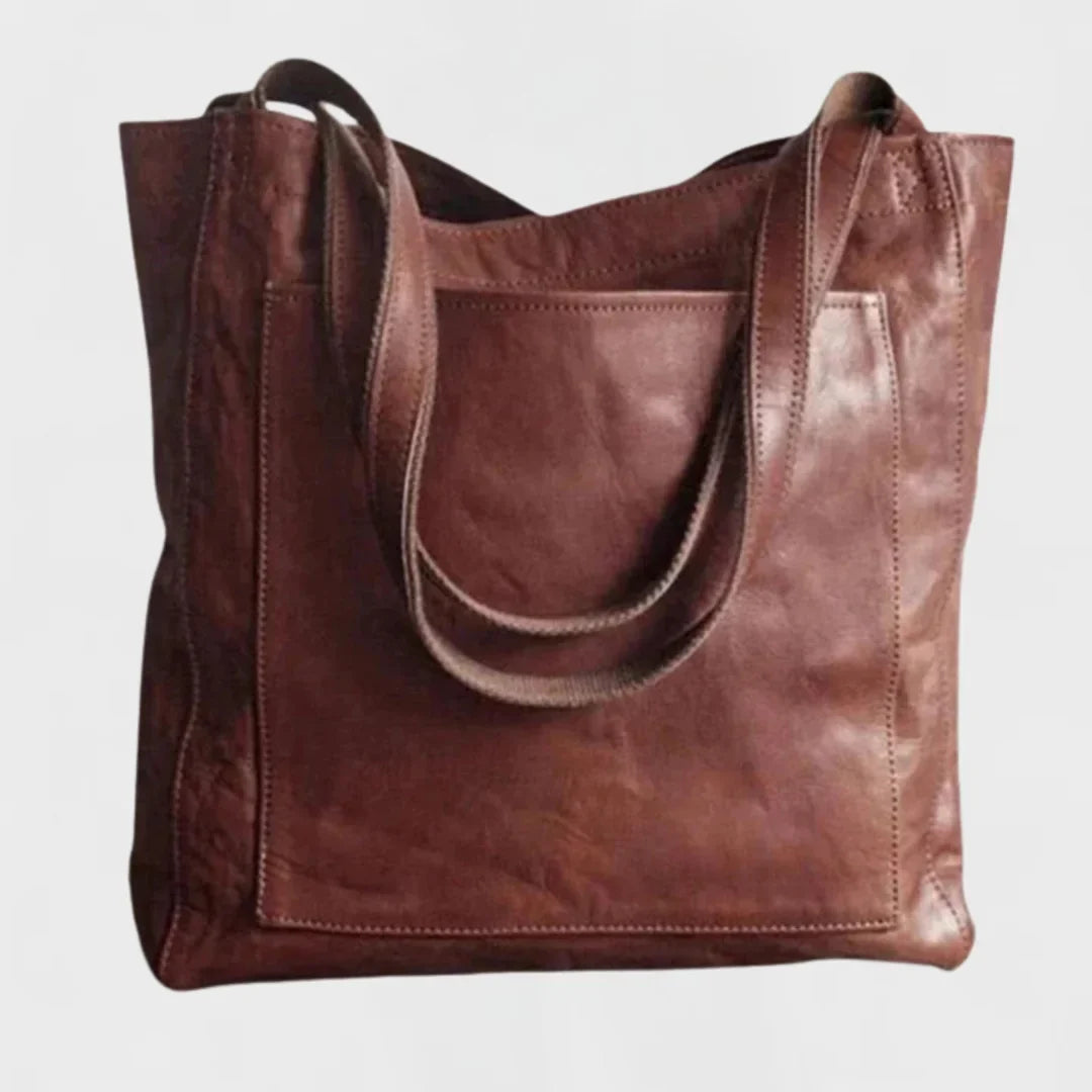 Elegant women's brown leather shoulder tote bag, large capacity design with convenient front pocket.