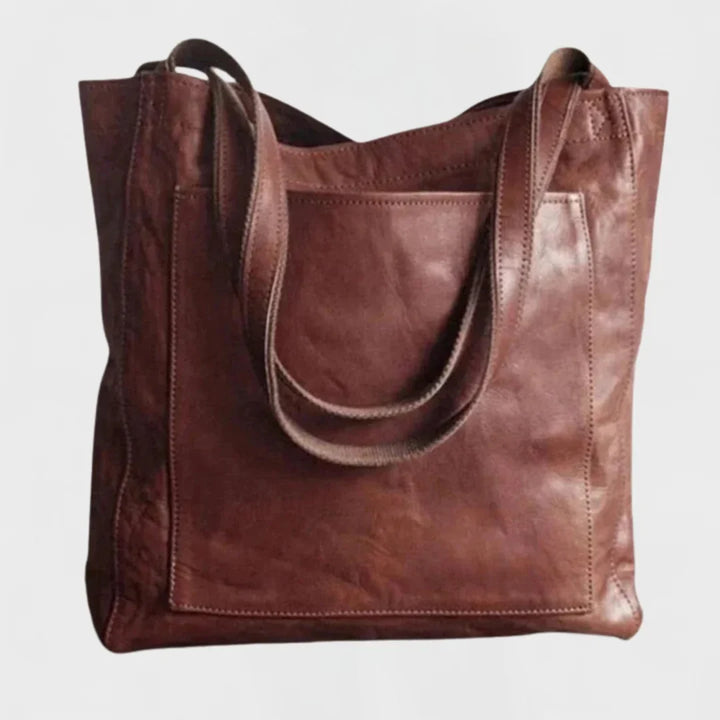 Elegant women's brown leather shoulder tote bag, large capacity design with convenient front pocket.