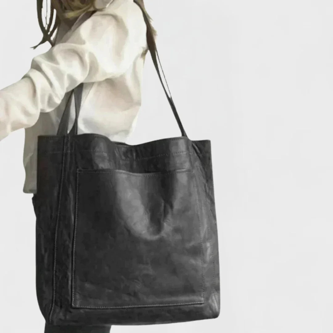 High-quality brown leather tote bag for women, durable and stylish, with a secure front pocket for essentials.