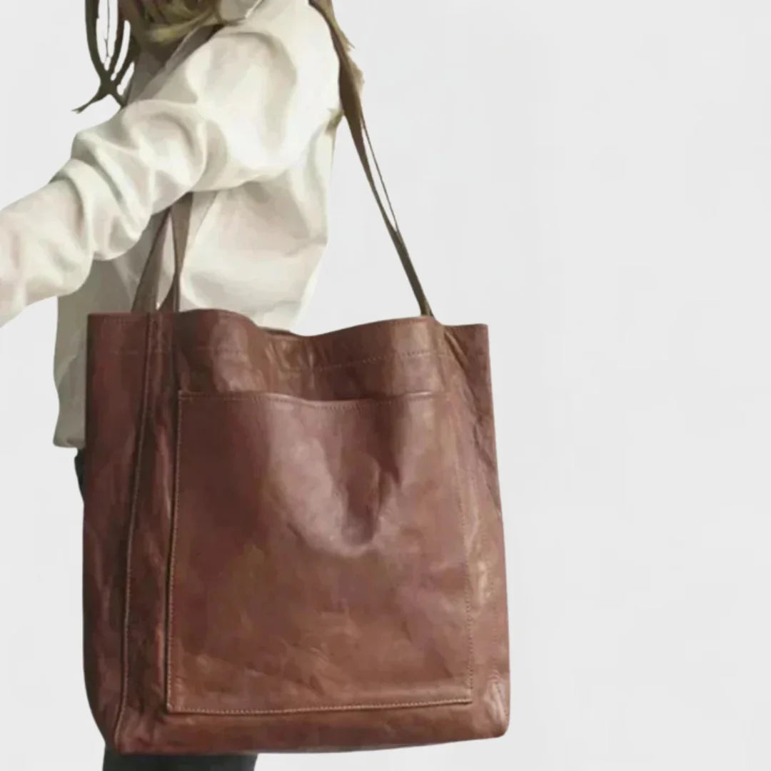 Chic brown leather everyday bag for women, a spacious tote with a stylish front pocket and comfortable handles.