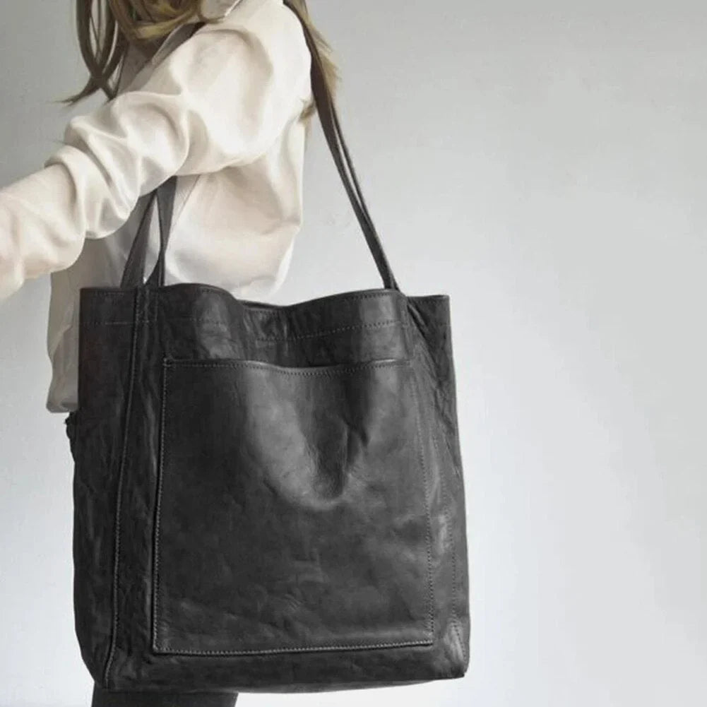 Elegant women's brown leather tote bag, a perfect shoulder or everyday handbag with magnetic snap and front pocket.