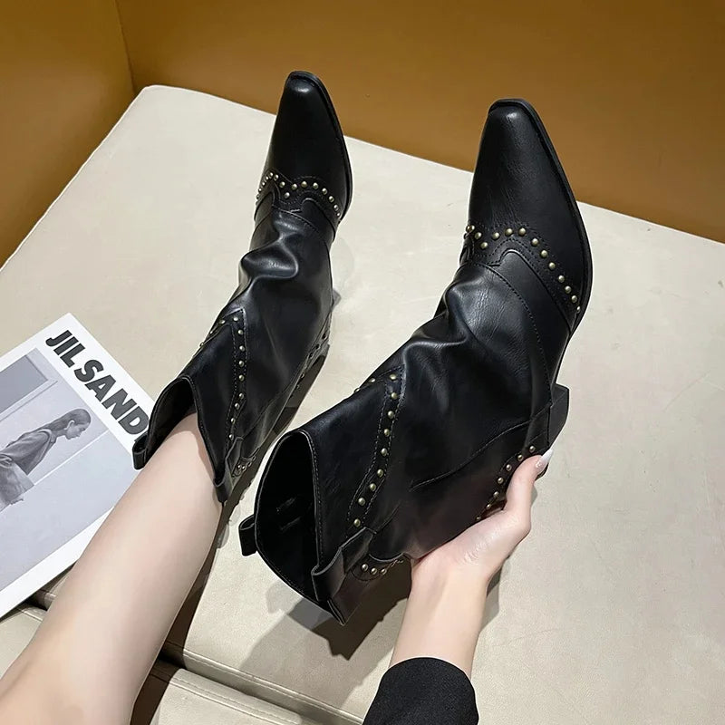 Edgy women's mid-calf boots, studded western style, sleek pointed toe.