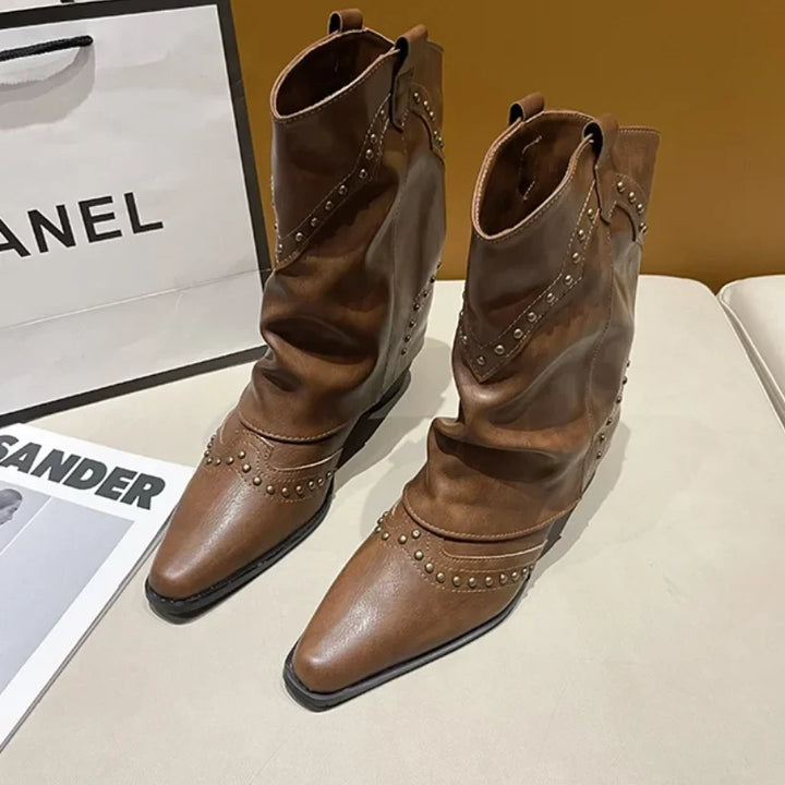 Women's mid-calf studded western boots with pointed toe & block heel.