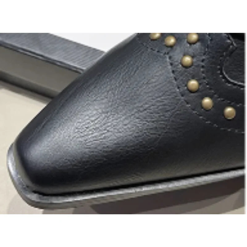 Black western boots with studs for women, mid-calf length, elegant pointed toe.