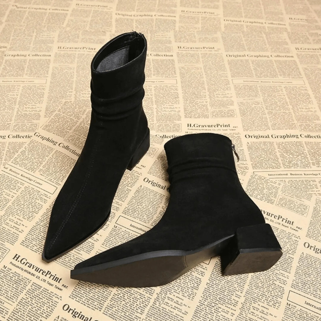 Full view of women's elegant brown slouchy ankle boots, showcasing the sleek pointed toe & sturdy block heel.