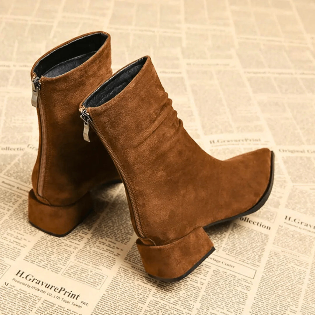 Women's fashion brown slouchy ankle boots. Features a trendy pointed toe & comfortable block heel for all-day wear.