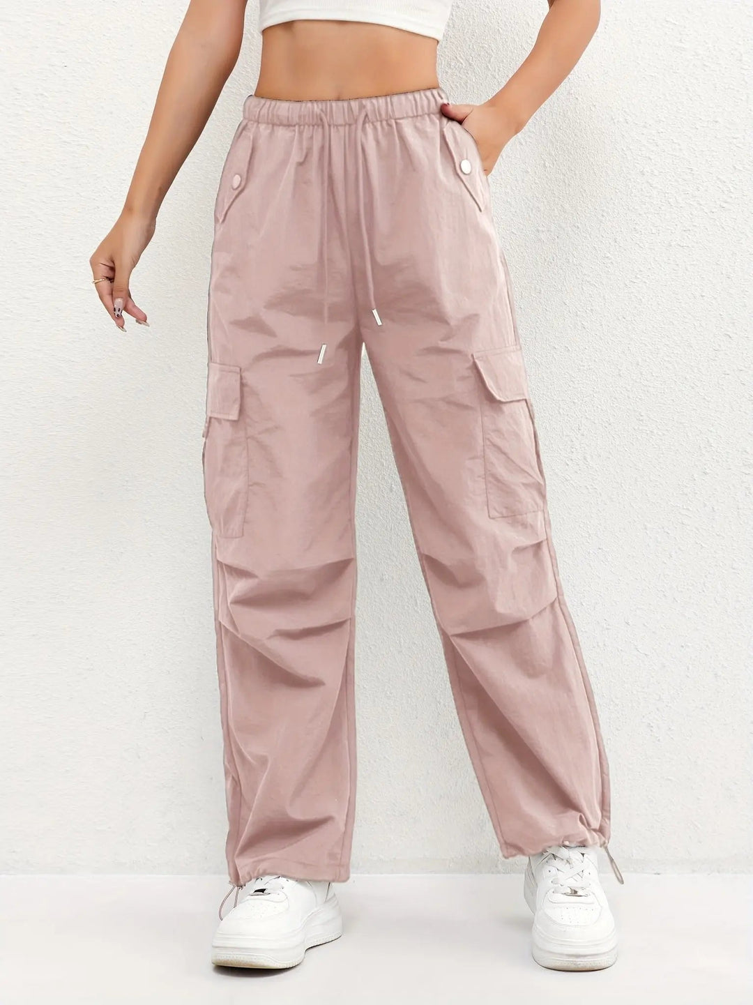 Women's black parachute cargo trousers, relaxed fit with adjustable waist, multiple pockets & drawstring ankles.