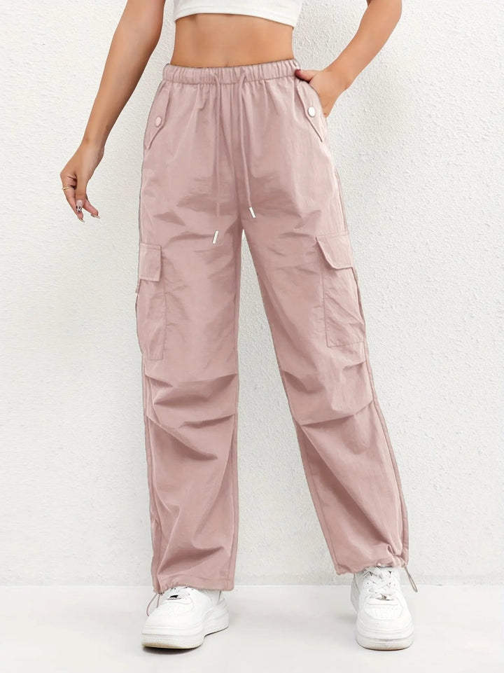 Women's black parachute cargo trousers, relaxed fit with adjustable waist, multiple pockets & drawstring ankles.