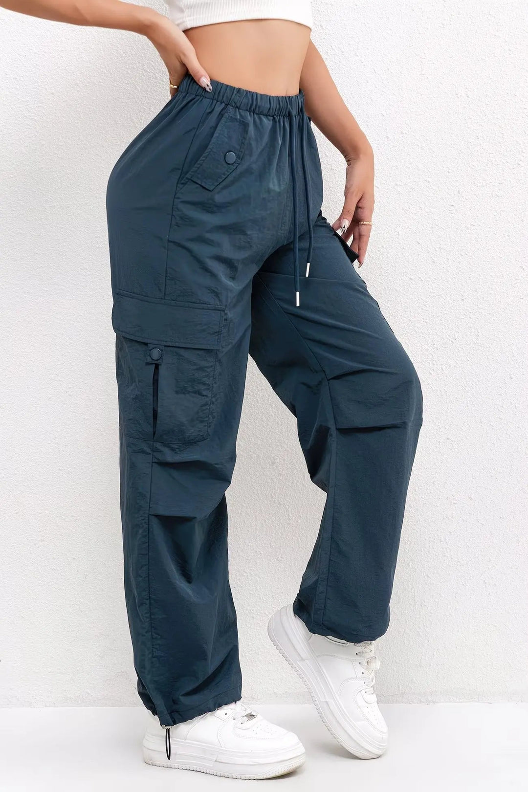 Trendy women's parachute trousers with wide relaxed leg & adjustable drawstring cuffs, perfect for street style fashion.