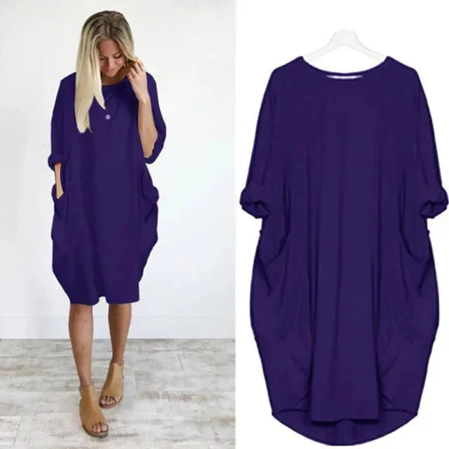 Close-up: Practical side pockets on a women's casual oversized midi dress with comfy 3/4 sleeves.