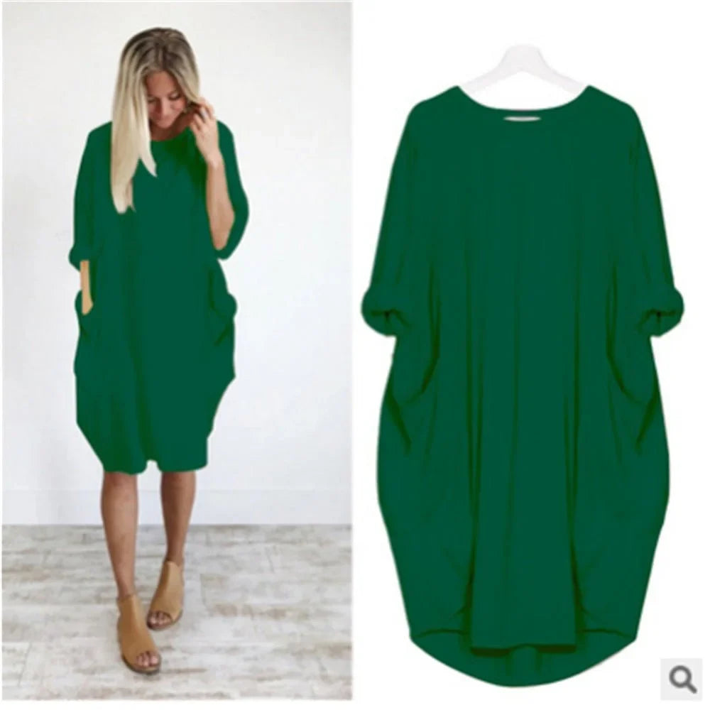 Side view: Flowy women's oversized midi dress, highlighting comfortable 3/4 sleeves & practical pockets.