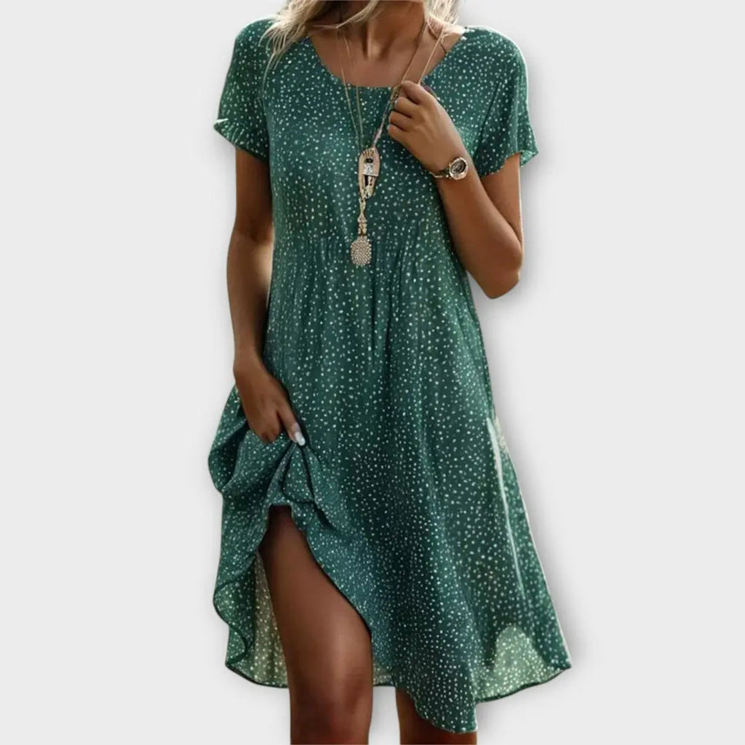 Chic women's casual polka dot flowy A-line short sleeve midi dress for comfortable summer fashion or vacation.