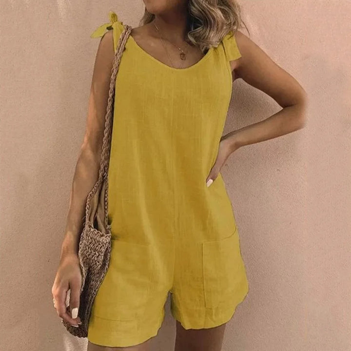 Stylish women's casual short jumpsuit featuring delicate bow straps & functional patch pockets for a chic look.