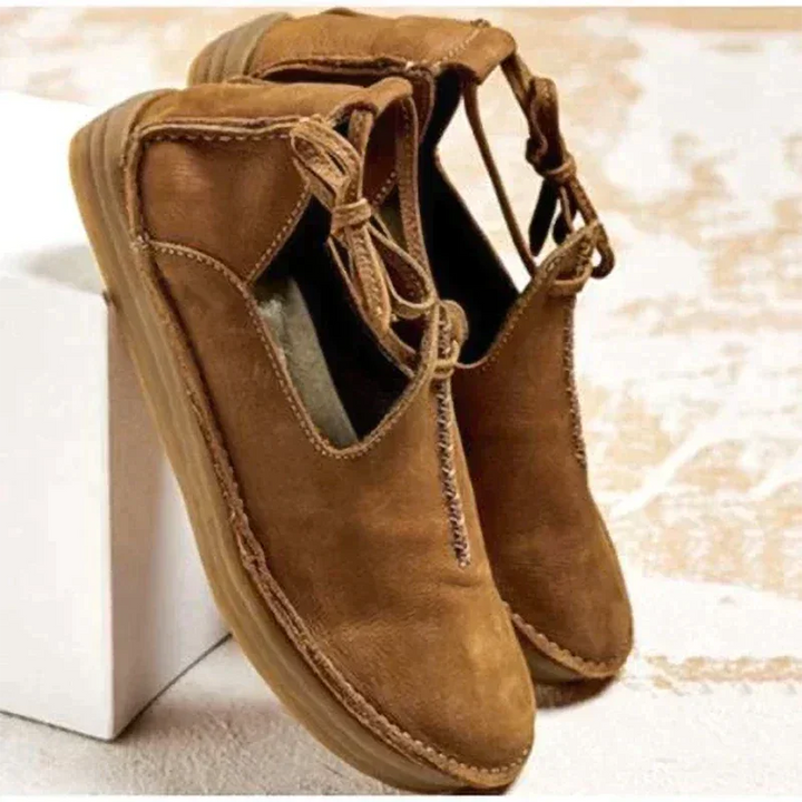 Fashionable women's dressy flats with elegant lace-up front and subtle decorative stitching.