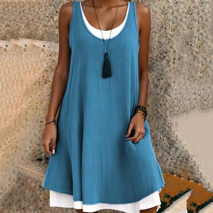Sleeveless A-line mini dress for women, casual layered style with scoop neck, ideal for summer travel and outfits.